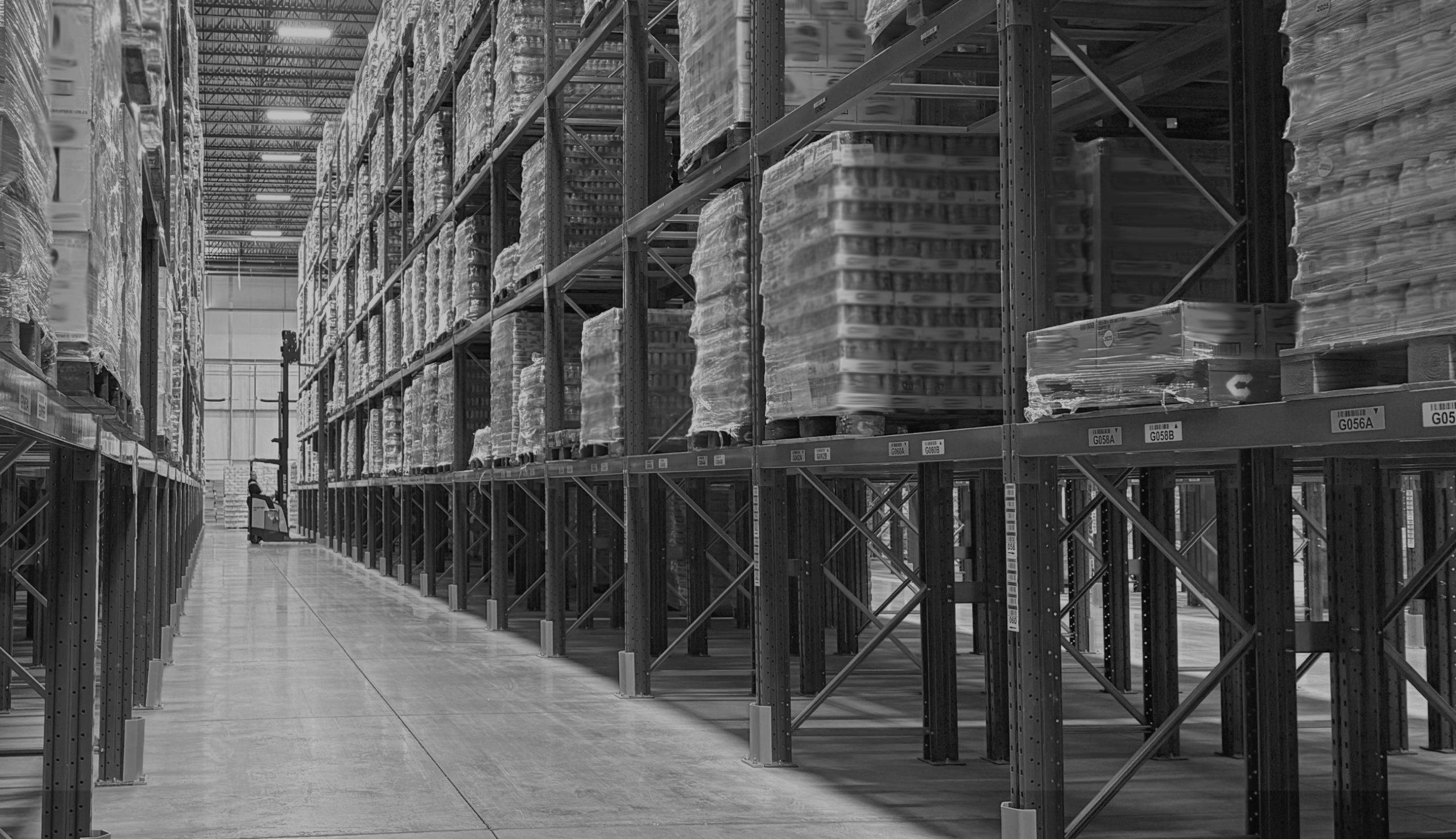 Forklift moving freight in a warehouse that has rail access inside building